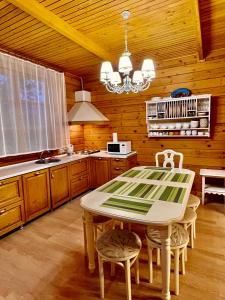 a kitchen with a table and chairs in a room at Family club Royal-apricot in Tamga