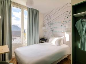 Postel nebo postele na pokoji v ubytování ibis Styles Asnieres Centre