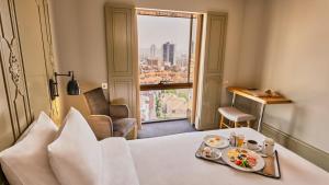 a hotel room with a table with a tray of food at The Cettia Istanbul in Istanbul