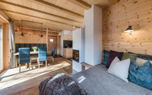 a living room and kitchen with a couch and a table at Grossplonerhof in Luson