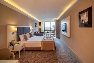 A bed or beds in a room at The Conforium Hotel Van