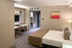 A bed or beds in a room at The Conforium Hotel Van