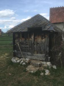 a small wooden cabin in a field at Ambar in Nova Varoš