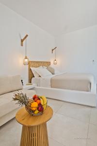 a room with a bowl of fruit on a table at Agnantema luxury suites in Karpathos