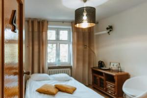a bedroom with a bed with two pillows on it at Rooms Gdańsk Wrzeszcz centrum in Gdańsk