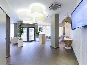 an office with a flat screen tv and a conference room at Kyriad Paris 18 - Porte de Clignancourt - Montmartre in Paris