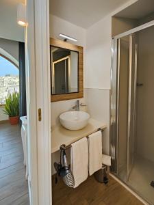 a bathroom with a sink and a mirror at The View Matera in Matera