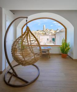 a basket on a stand in a room with a window at The View Matera in Matera