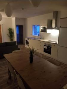 a living room with a wooden table and a kitchen at Just Renovated Galway City Apartment in Galway