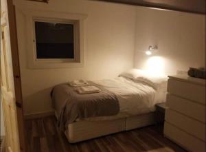 a small bedroom with a bed and a window at Just Renovated Galway City Apartment in Galway