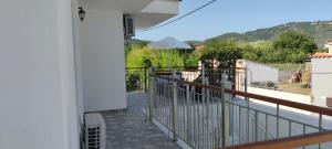 a balcony with a view of a yard at Meraki Skopelos in Skopelos Town