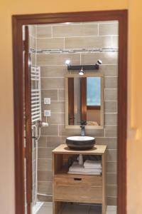 a bathroom with a sink and a mirror at Chalet Ouréa in Campan