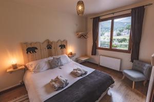 a bedroom with a large bed and a window at Chalet Ouréa in Campan