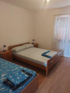 Postel nebo postele na pokoji v ubytování Apartments Vilanija