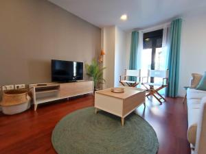 A television and/or entertainment centre at Expoholidays - Apartamento Rueda Lopez (7ºB)
