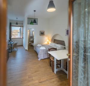 a bedroom with a bed and a table in a room at The View Matera in Matera