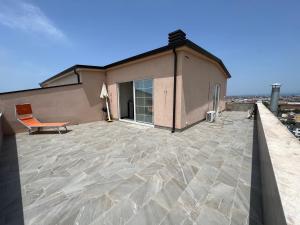 a balcony with a chair on top of a building at Ada’s house in Durrës
