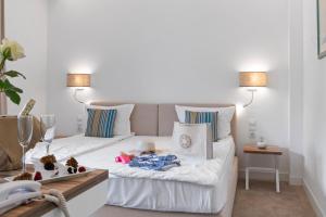 a living room with a white couch with two lamps at Nympha Hotel, Riviera Holiday Club - All Inclusive in Golden Sands