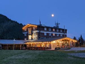 a large building with lights on it at night at Hotel Srdiečko in Tale