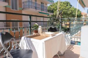 a white table and chairs on a balcony at [V.LE DELLA REPUBBLICA] Bilocale vicino al mare. in Pietra Ligure +3 photos