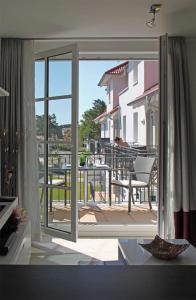 a room with a sliding glass door to a balcony at Haus Meeresblick - Ferienwohnung Windlicht A 2.08 (Ref. 128696) in Baabe