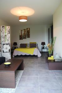 a bedroom with a bed with a yellow blanket at Maison de 3 chambres avec jardin clos et wifi a Mouzillon in Mouzillon