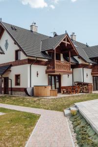 a large house with a porch and a patio at Pieninski relaks in Jaworki