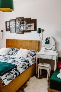 a bedroom with a bed and a table with a mirror at Pieninski relaks in Jaworki