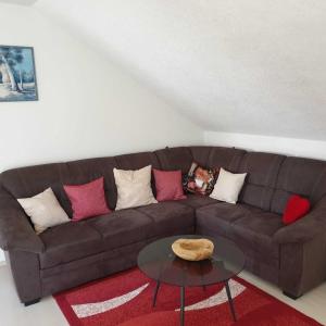 a living room with a brown couch and a table at M&J FeWo in Kappel-Grafenhausen +19 photos