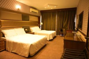 Postel nebo postele na pokoji v ubytování ABJAD CROWN HOTEL