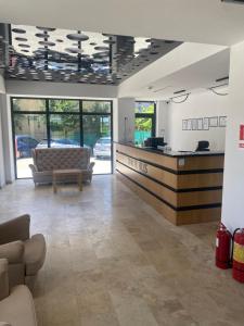 a lobby with a couch and a reception desk at Hotel Alis in Eforie Nord