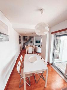a dining room with a white table and chairs at Casa da Aldeia in Constância +43 photos