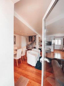 a living room and dining room with a table and chairs at Casa da Aldeia in Constância