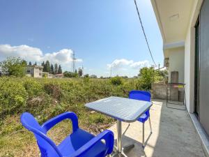 a table and chairs on the porch of a house at Rion Apartments in Ulcinj