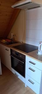 a kitchen with a sink and a stove top oven at B&B Talstation Ferienwohnung für 2 Personen in Hörselberg-Hainich