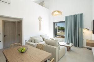 a living room with a couch and a table at SEASCAPE VILLAS VASSILIKI - Beachfront villas in Vasiliki