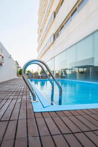 a slide in a pool next to a building at Hotel Xon's Valencia in Aldaya