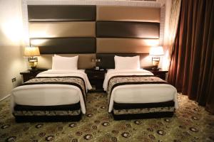 Postel nebo postele na pokoji v ubytování ABJAD CROWN HOTEL