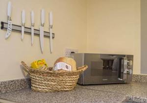 un panier sur un comptoir à côté d'un micro-ondes dans l'établissement Cosy Cottage In Cardigan, à Cardigan