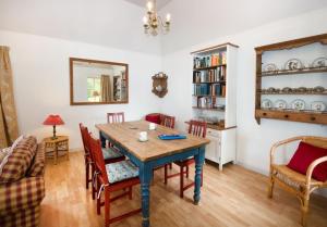a dining room with a table and chairs at Gardener's Cottage in Elgin