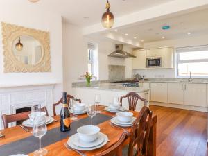 a kitchen and dining room with a table and chairs at Temple House in Sidmouth
