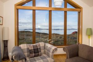 a living room with a couch and a large window at St Clements View in Rodel