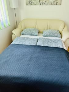 a blue bed with two pillows on top of it at Apartment Prague-2 rooms free parking in Prague