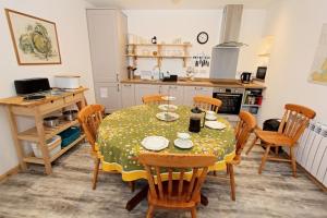 a dining room with a table and chairs in a kitchen at Taigh Eachainn in Valtos