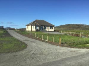 a small house on the side of a dirt road at Lingeigh in Pollachar