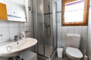 a bathroom with a sink and a shower and a toilet at Haus Lotus, Riederalp Moosfluhbahn in Riederalp +33 photos