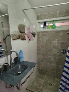 a bathroom with a sink and a shower at Guest house Ashdod-beach in Ashdod