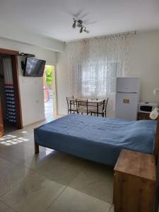 a bedroom with a blue bed and a table at Guest house Ashdod-beach in Ashdod