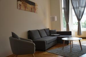 a living room with a couch and a table at Kokon Apartments in Leipzig