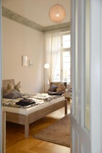 a bedroom with a bed in a room with a window at Kokon Apartments in Leipzig